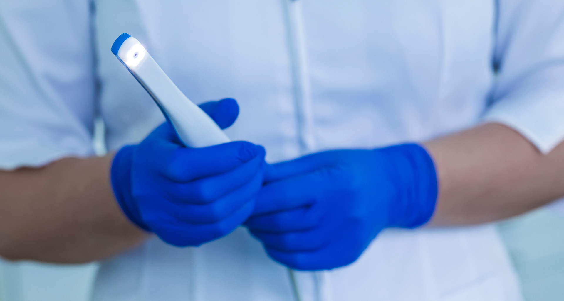 Dentist using an intra-oral camera during a patient examination